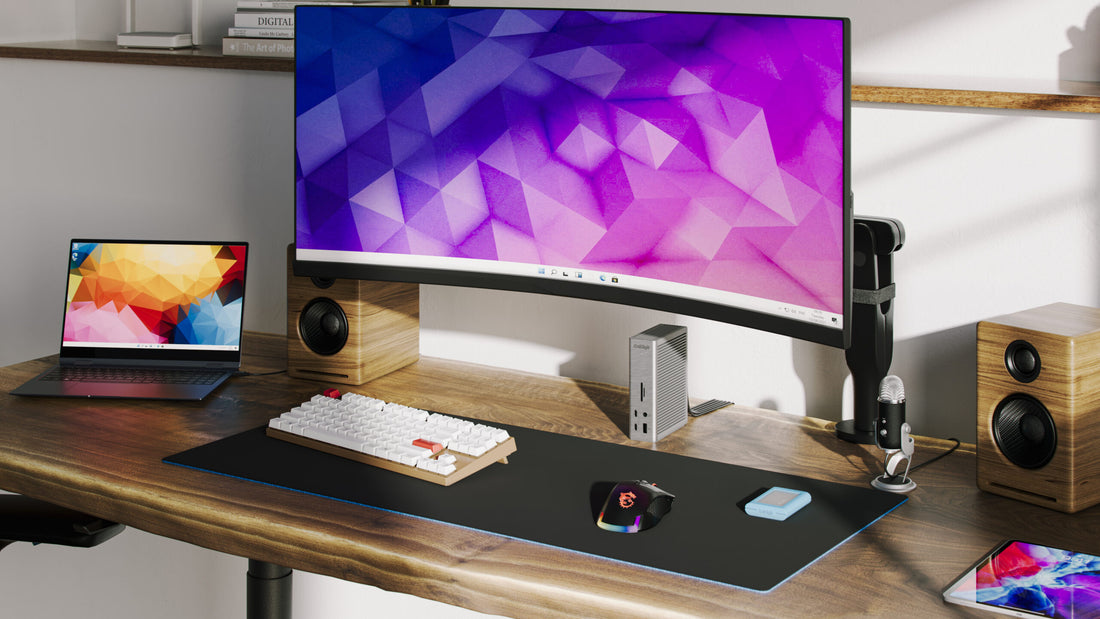 A desk with a CalDigit TS4 dock connected to a MacBook Pro and an ultra-wide monitor