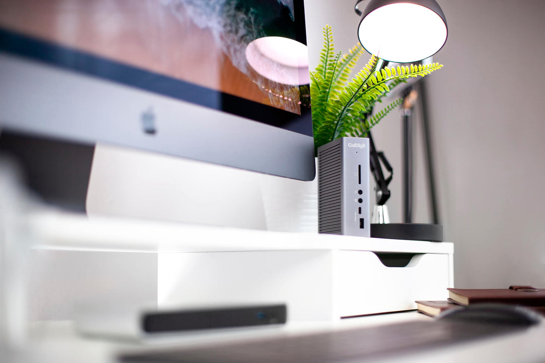 A TS3 Plus dock on a desk next to an iMac.