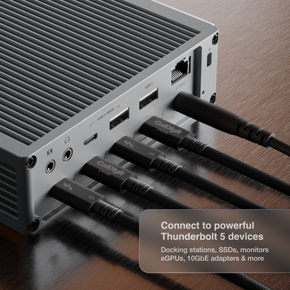 A close-up of 4 CalDigit Thunderbolt 5 cables plugged into the back of a CalDigit TS5. A text overlay in the bottom right corner reads 'Connect to powerful Thunderbolt 5 devices'.