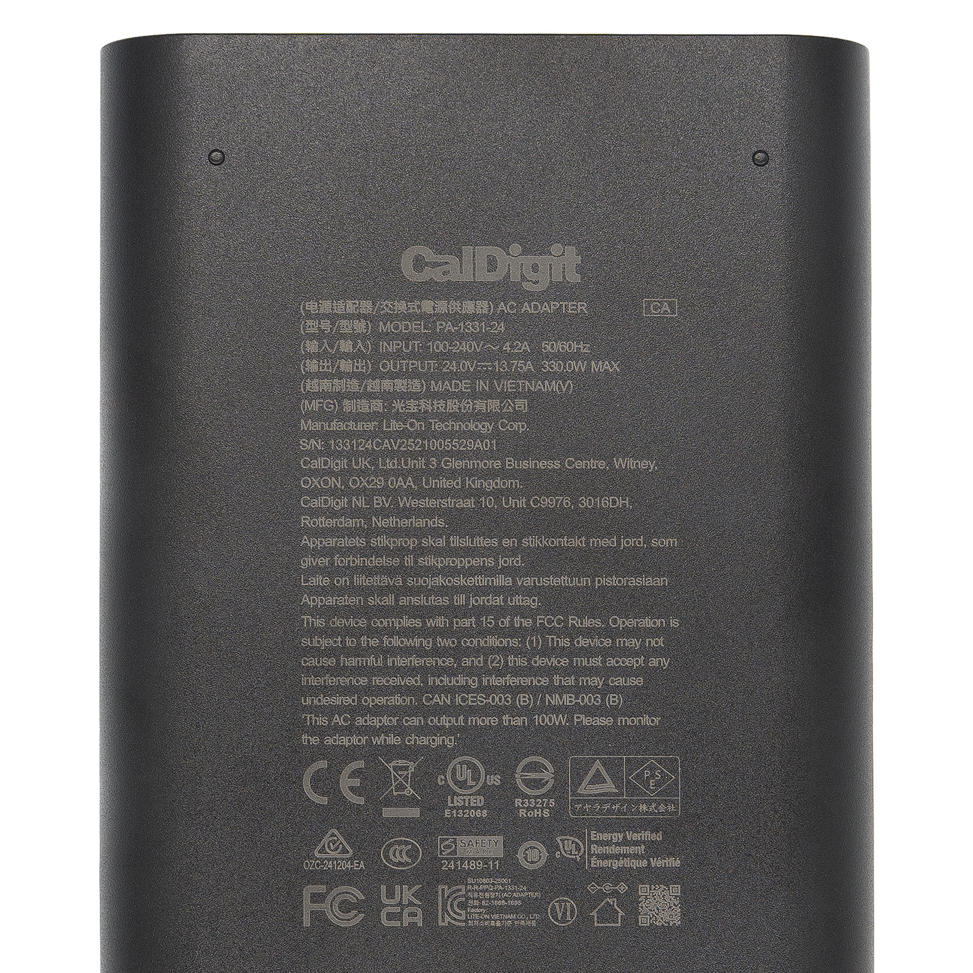Back view of a CalDigit AC adapter with text and logos.