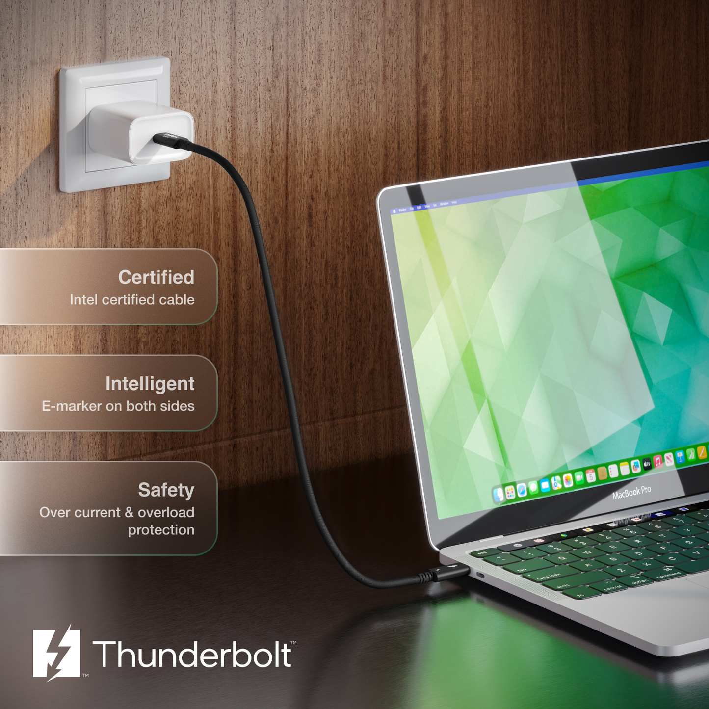 Laptop connected to a power outlet with Thunderbolt branding on a wooden background