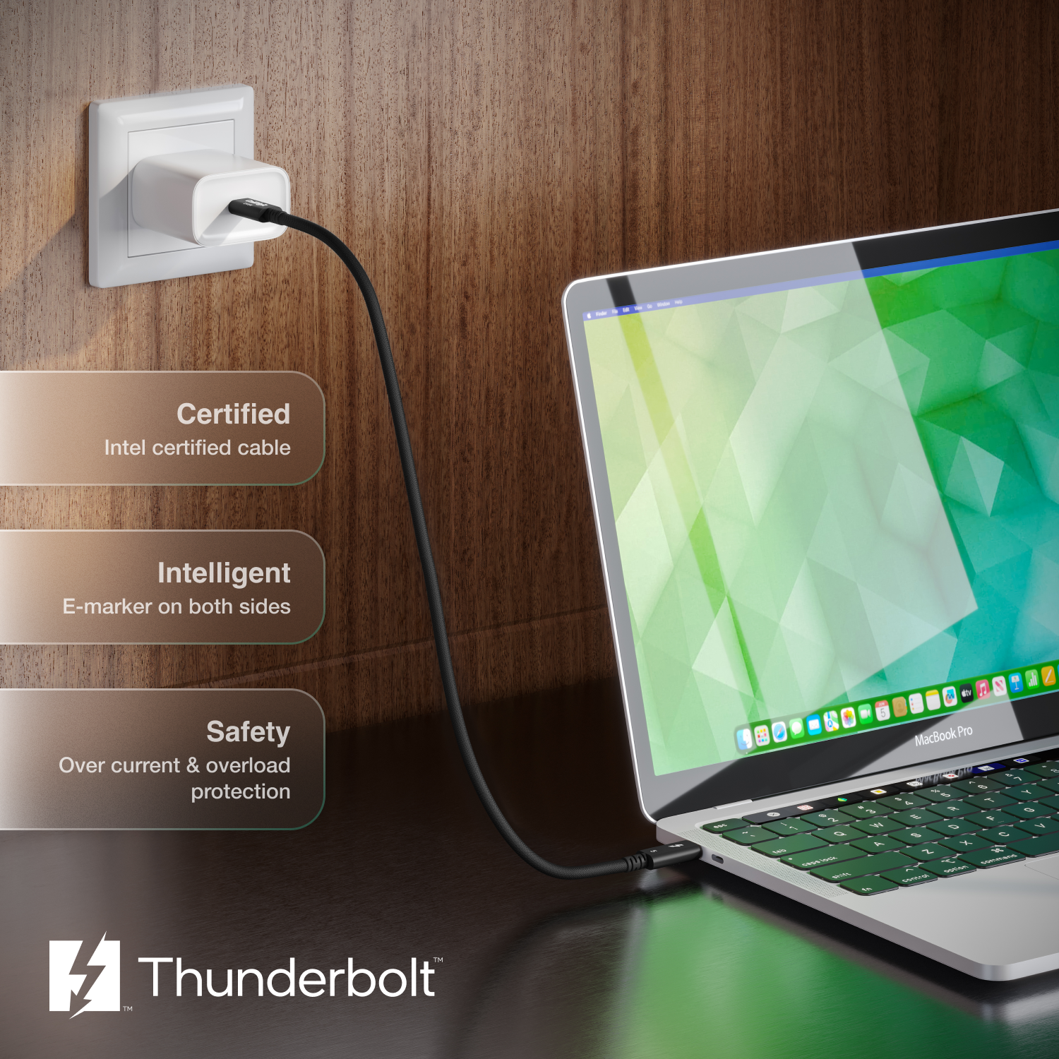 Laptop connected to a power outlet with Thunderbolt branding on a wooden background