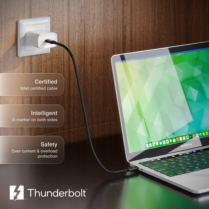 Laptop connected to a power outlet with Thunderbolt branding on a wooden background